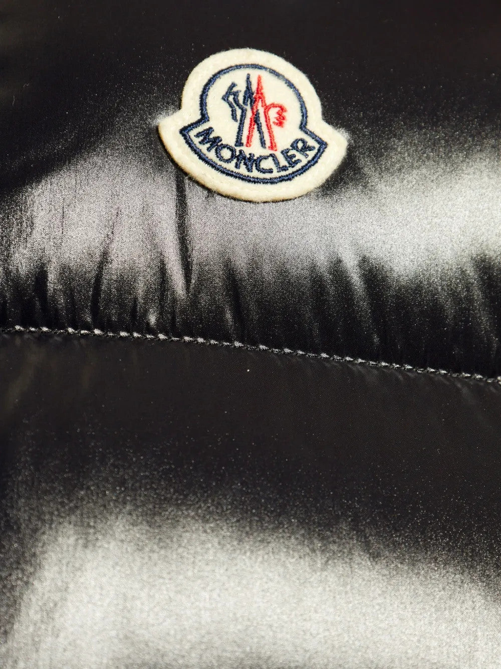 Close up of Black jacket, showing texture of the 100% polyamide fabric