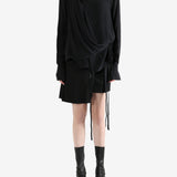 Black top worn by a person, showing the top's fit