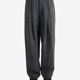 Black pants,worn by a person, showing the pants's fit