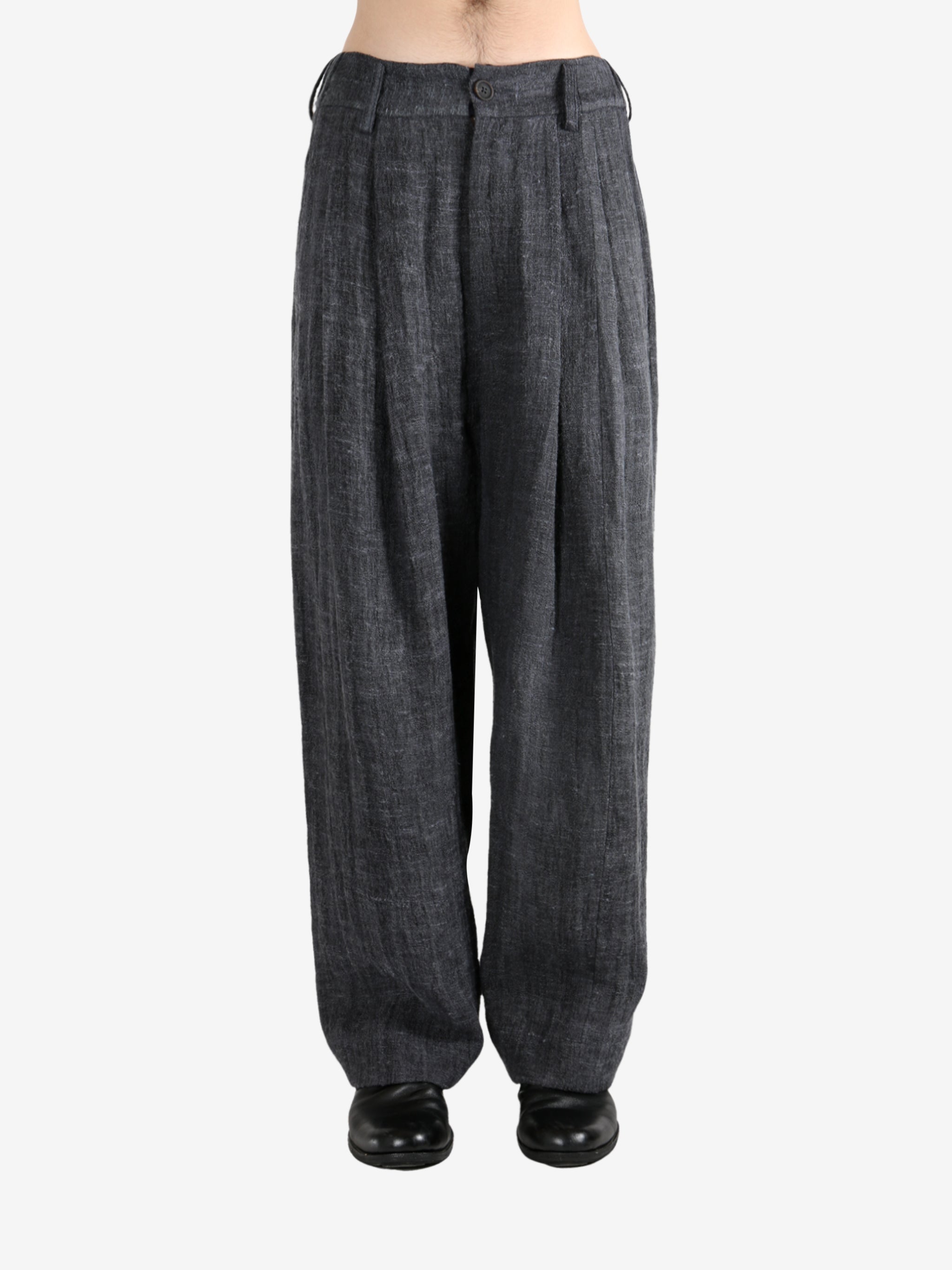 Black pants,worn by a person, showing the pants's fit