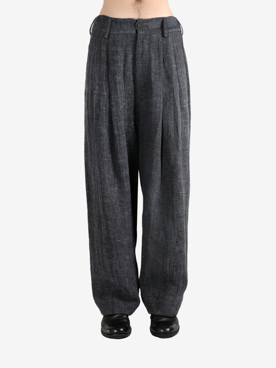 Black pants,worn by a person, showing the pants's fit