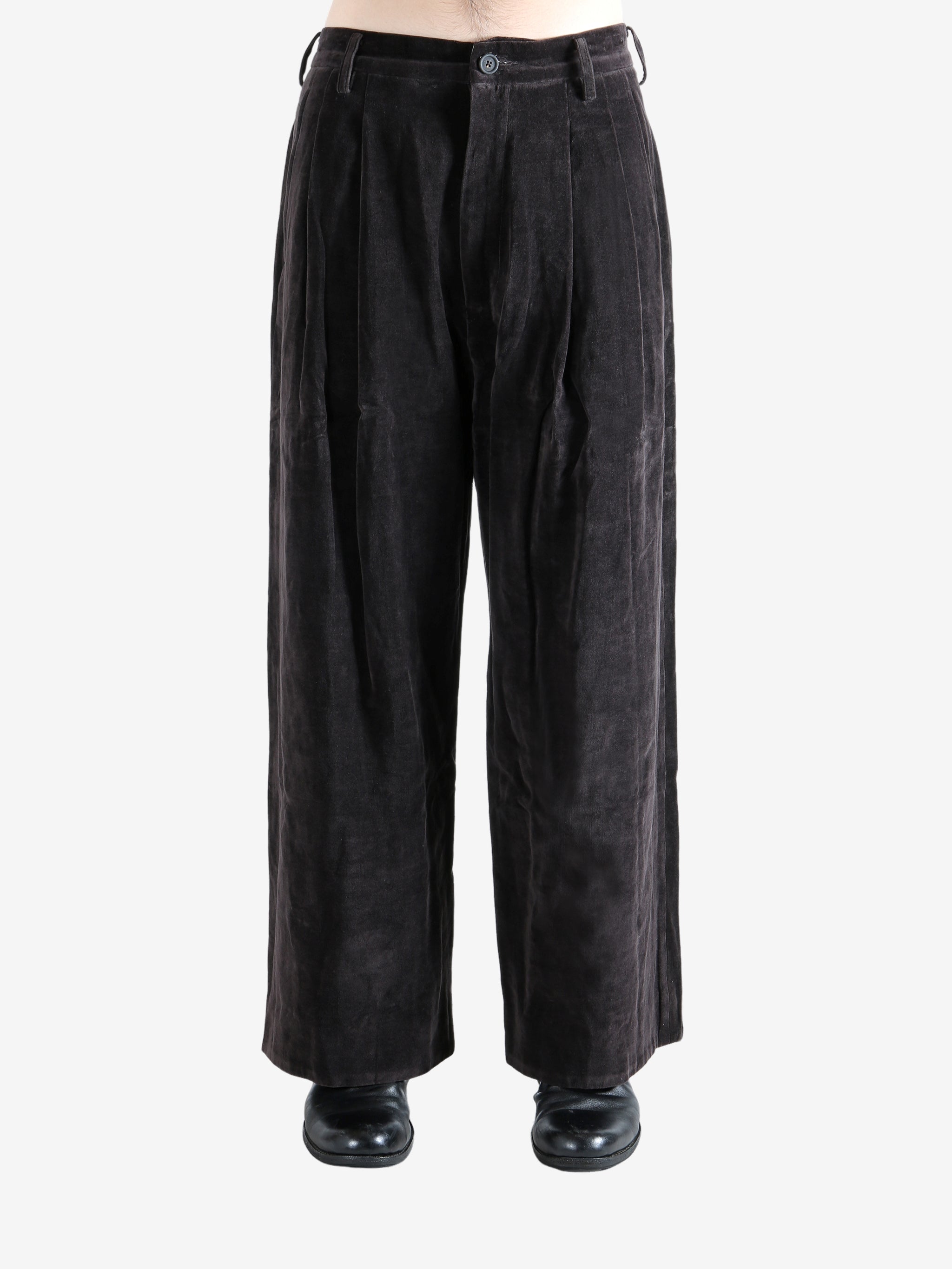 Brown pants worn by a person, showing the pants' fit