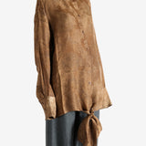 Brown top worn by a person, showing the top's fit