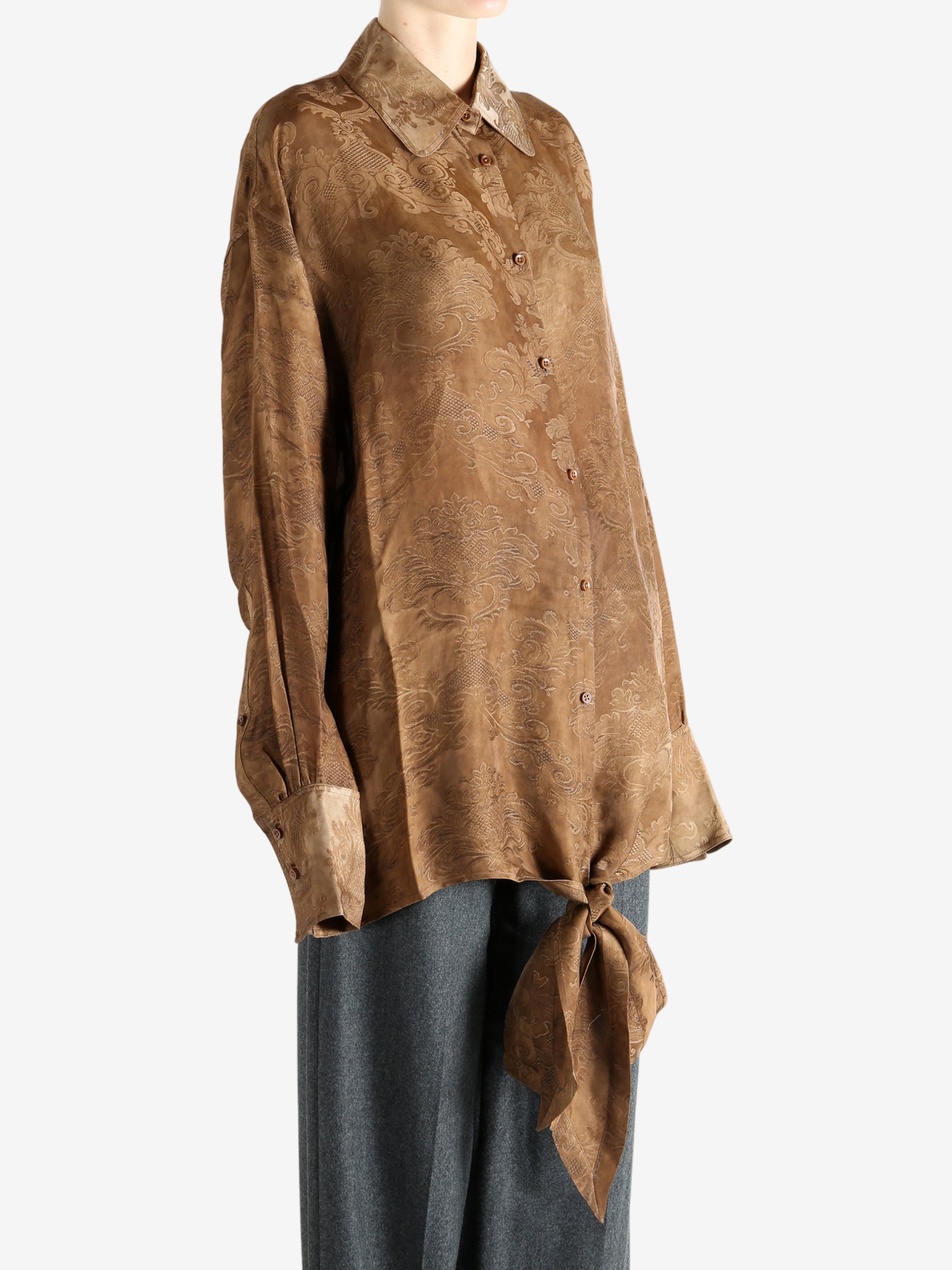 Brown top worn by a person, showing the top's fit