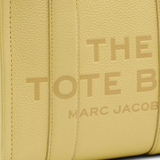 Close up of yellow bag, showing texture of the leather fabric