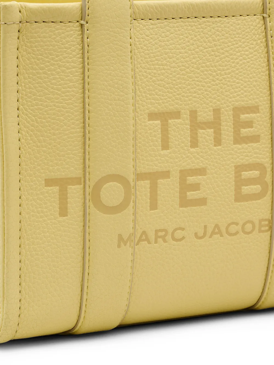 Close up of yellow bag, showing texture of the leather fabric