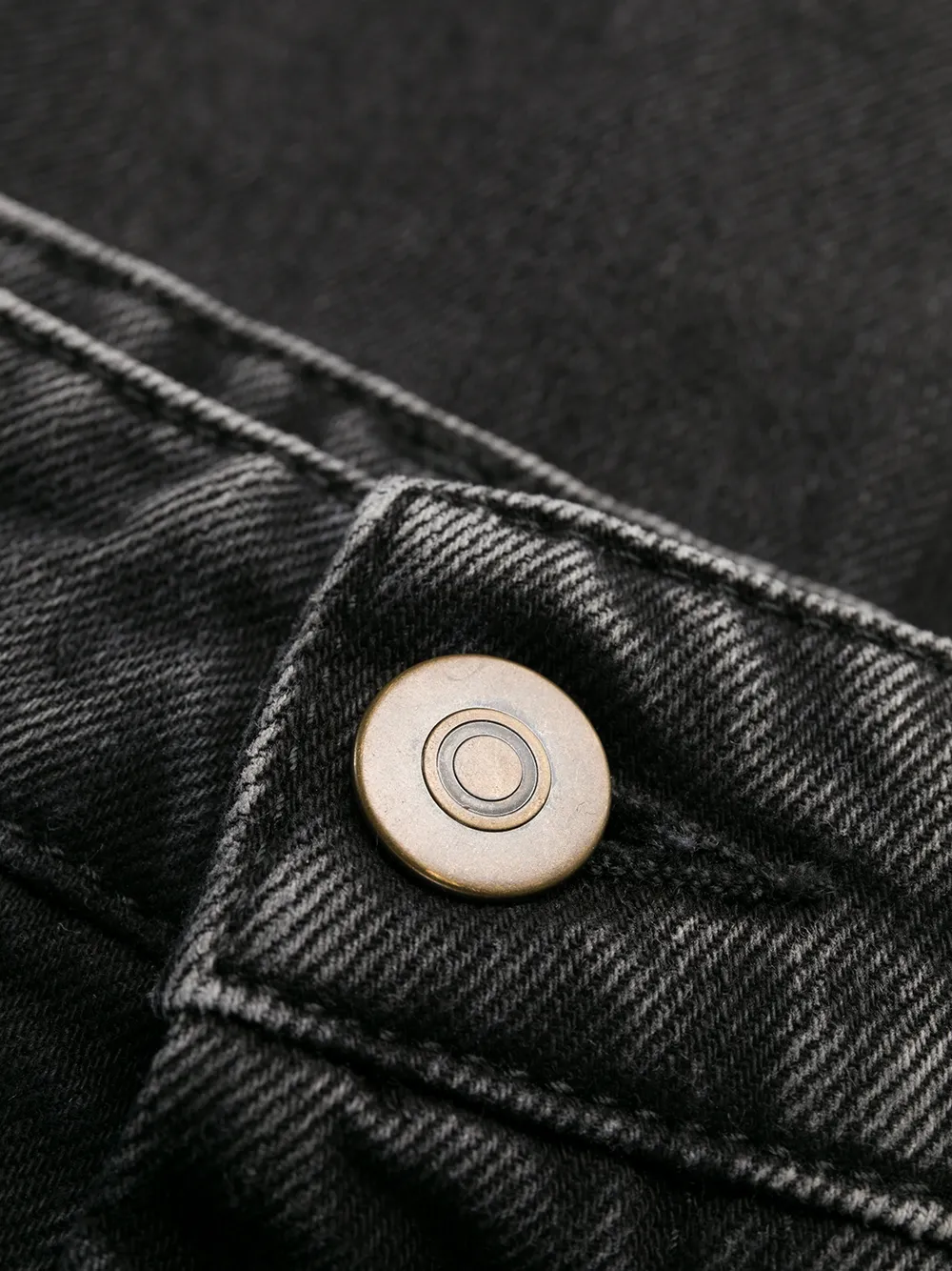 Close up of black pants, showing texture of the Denim fabric