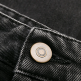 Close up of black pants, showing texture of the Denim fabric