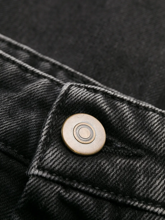 Close up of black pants, showing texture of the Denim fabric