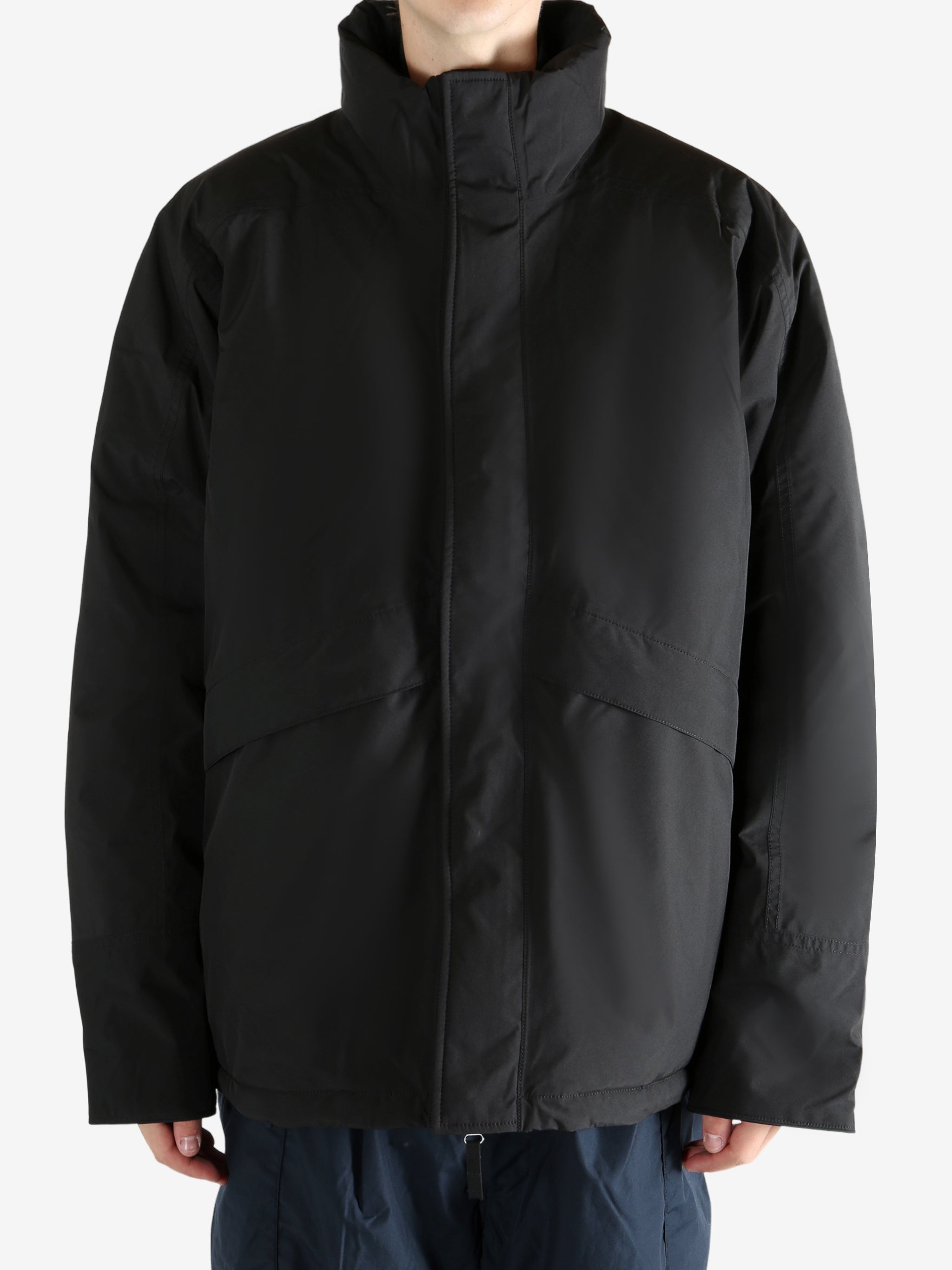 Black jacket worn by a person, showing the jacket's fit