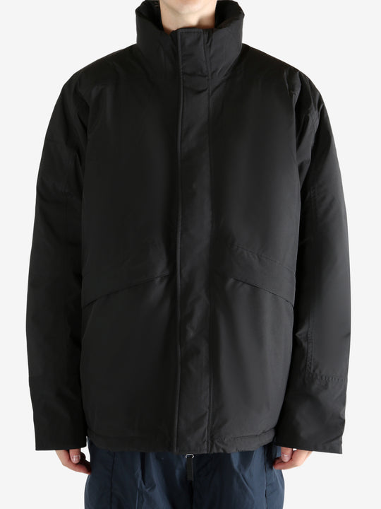 Black jacket worn by a person, showing the jacket's fit