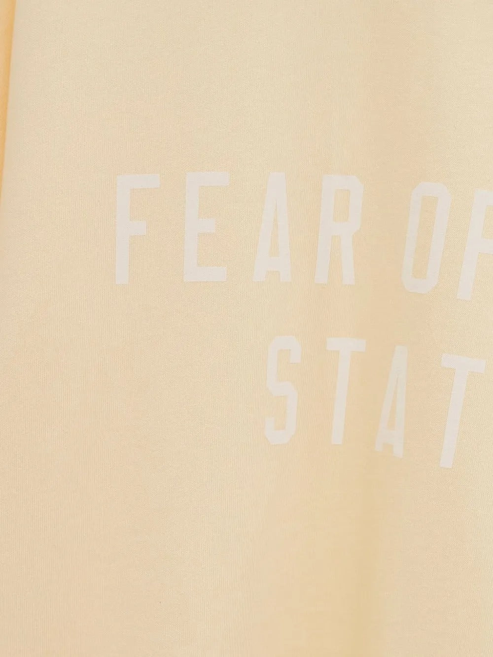 Close up of the yellow t-shirt, showing texture of the cotton fabric