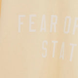 Close up of the yellow t-shirt, showing texture of the cotton fabric