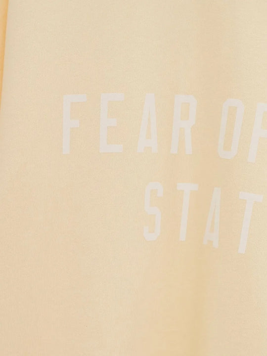 Close up of the yellow t-shirt, showing texture of the cotton fabric