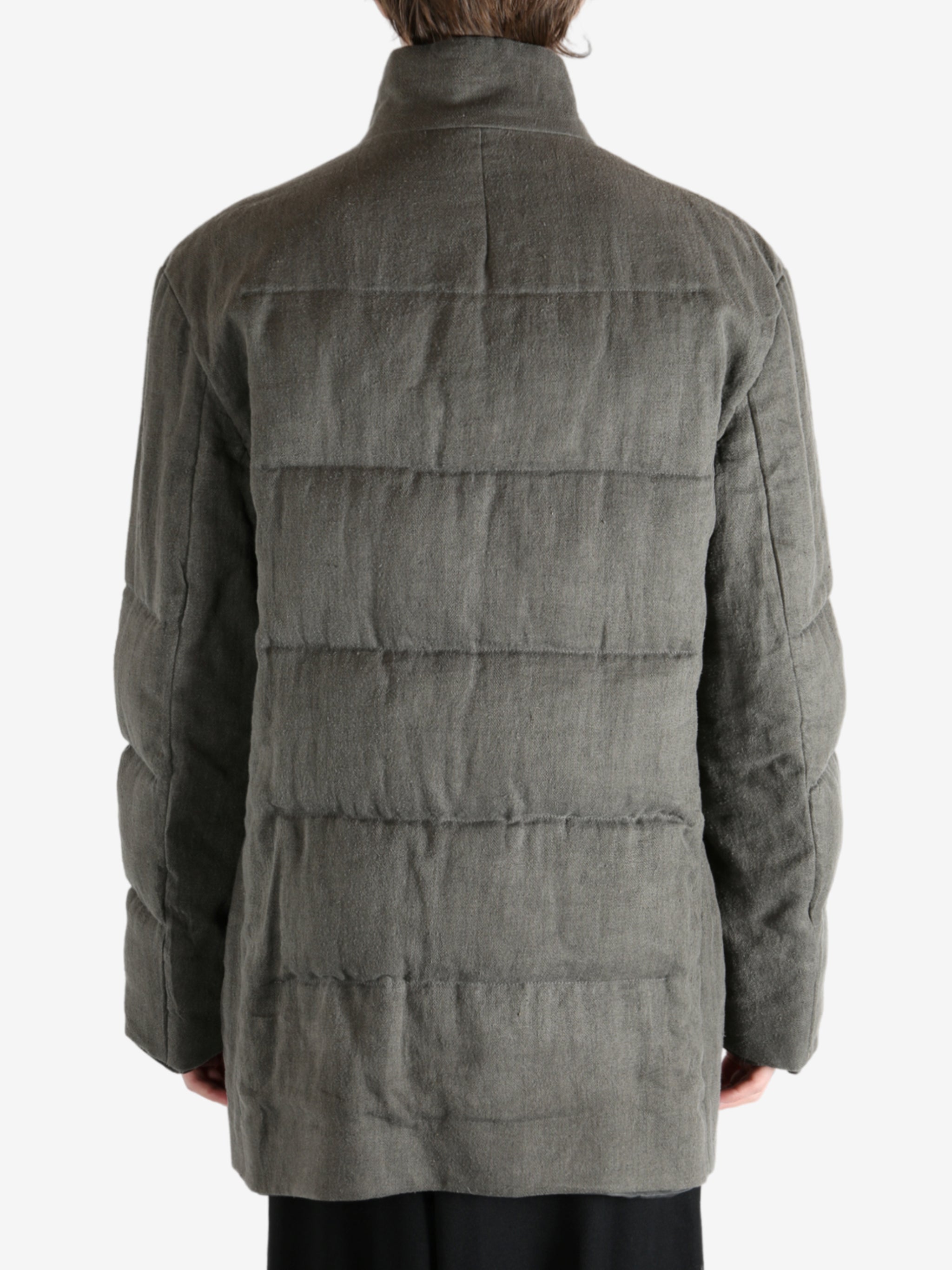 Grey jacket worn by a person, showing the jacket's fit