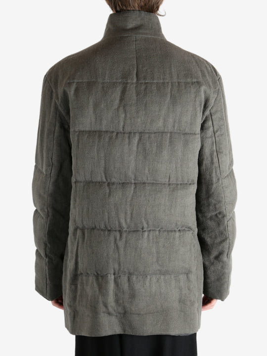 Grey jacket worn by a person, showing the jacket's fit