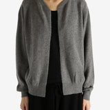 Grey knitwear worn by a person, showing the knitwear's fit