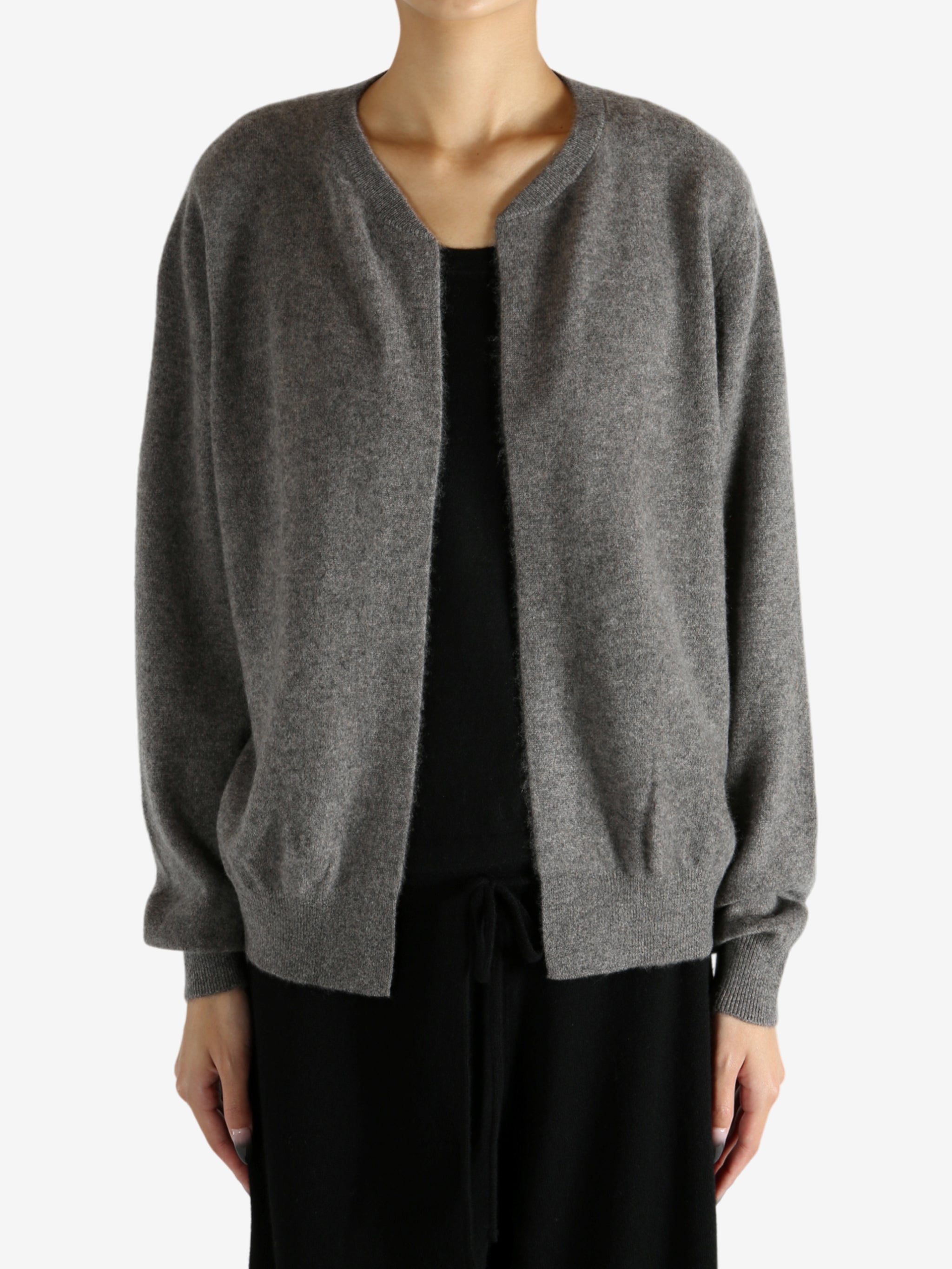 Grey knitwear worn by a person, showing the knitwear's fit