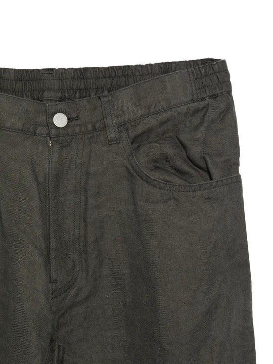 Close up of grey pants, showing texture of the cotton fabric