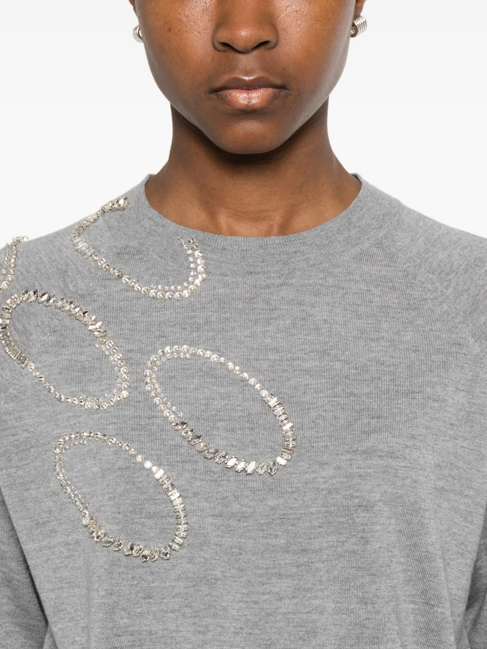 Close up of grey sweater, showing texture of the wool fabric