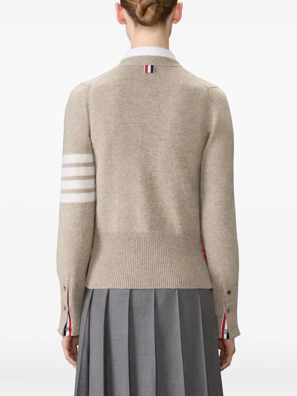 tan knitwear worn by a person, showing the knitwear fit