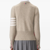 tan knitwear worn by a person, showing the knitwear fit