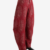 Red pants worn by a person, showing the pants's fit