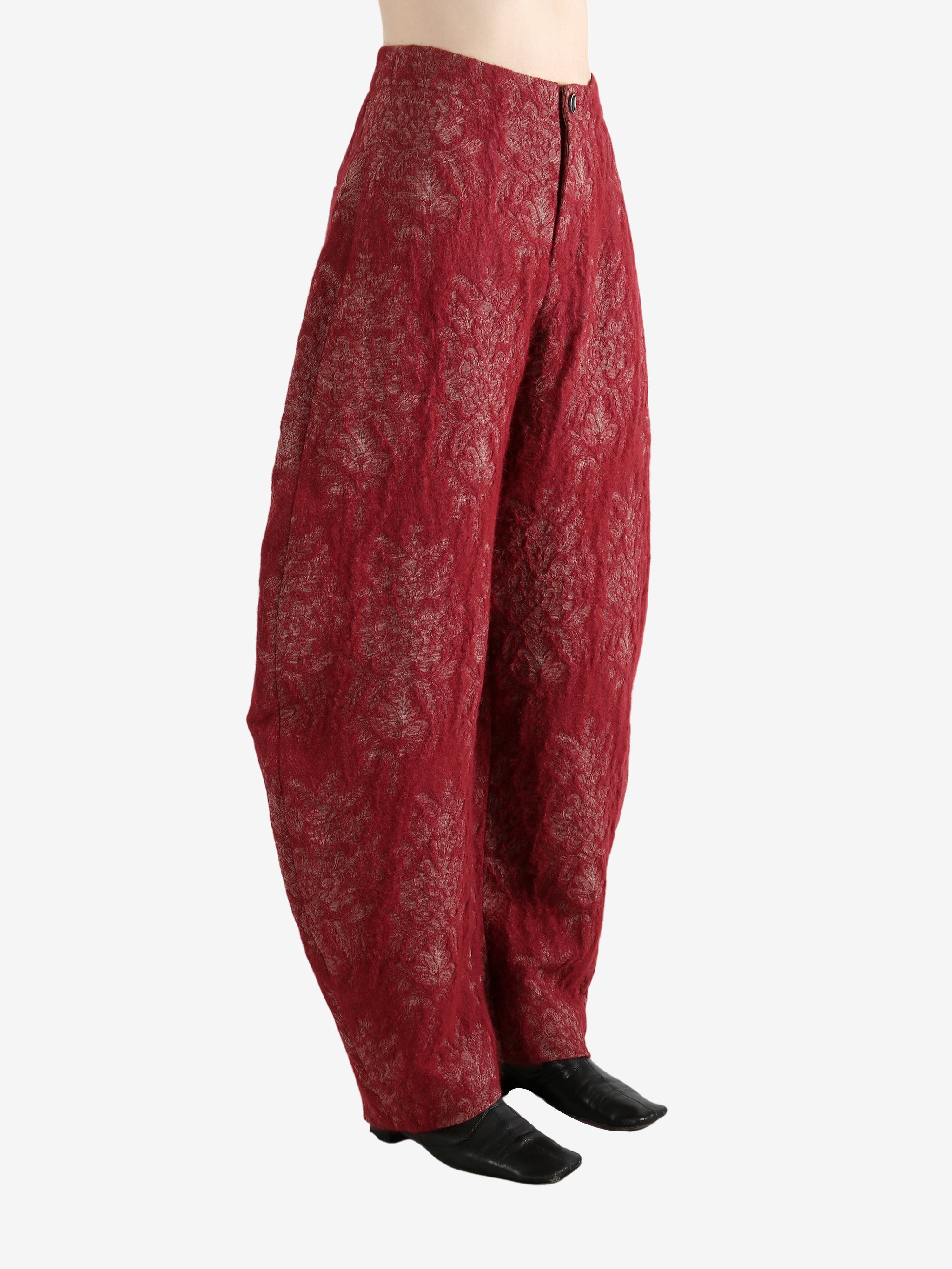 Red pants worn by a person, showing the pants's fit