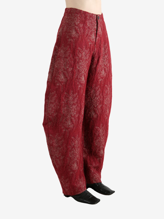 Red pants worn by a person, showing the pants's fit