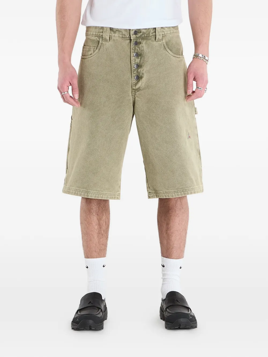 Green shorts worn by a person, showing the shorts fit