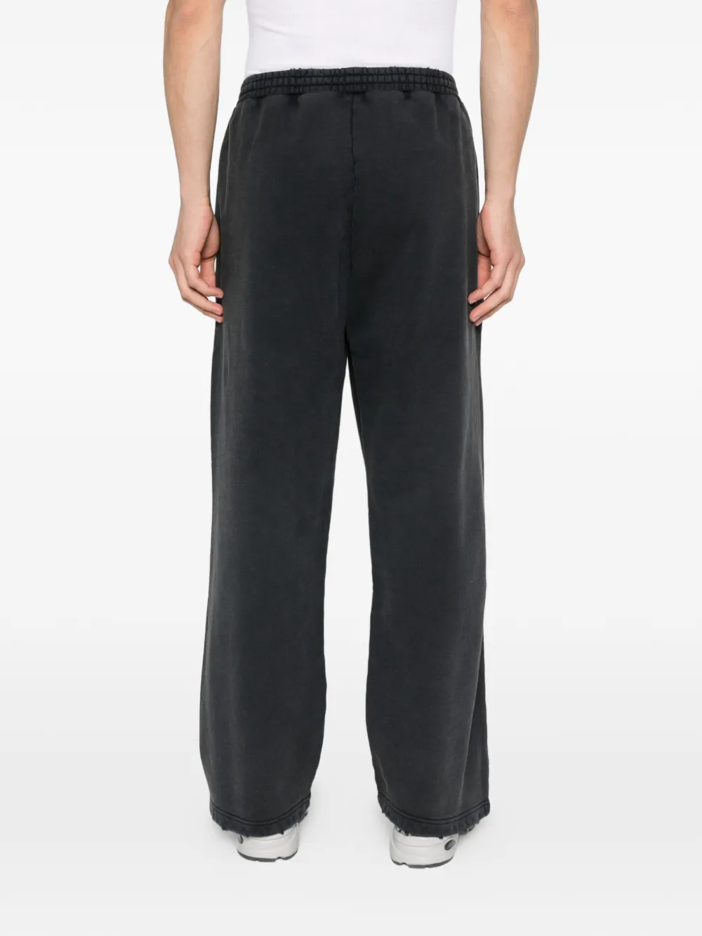 black pants worn by a person, showing the pants fit