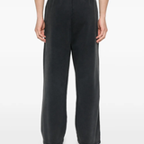black pants worn by a person, showing the pants fit