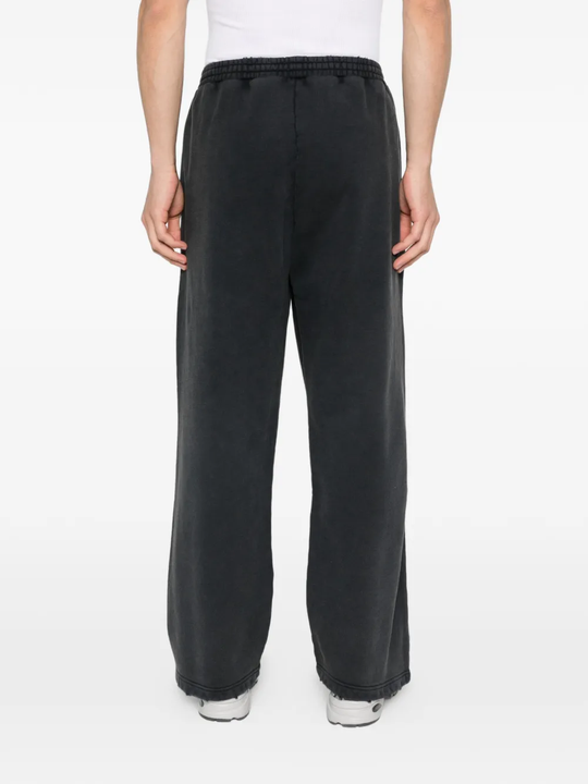 black pants worn by a person, showing the pants fit