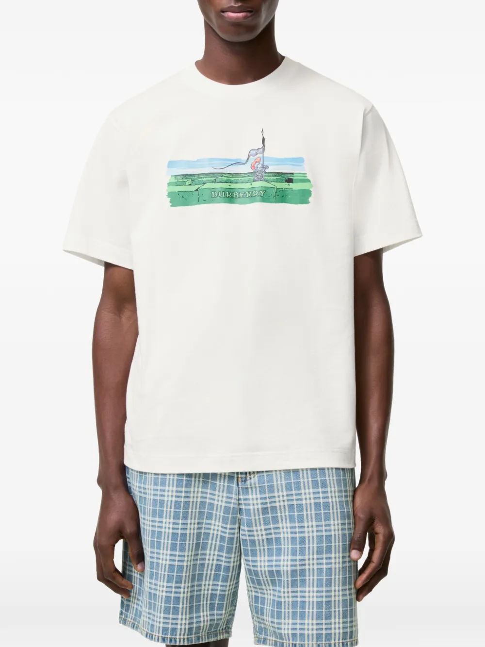 White t-shirt worn by a person, showing the white t-shirt's fit