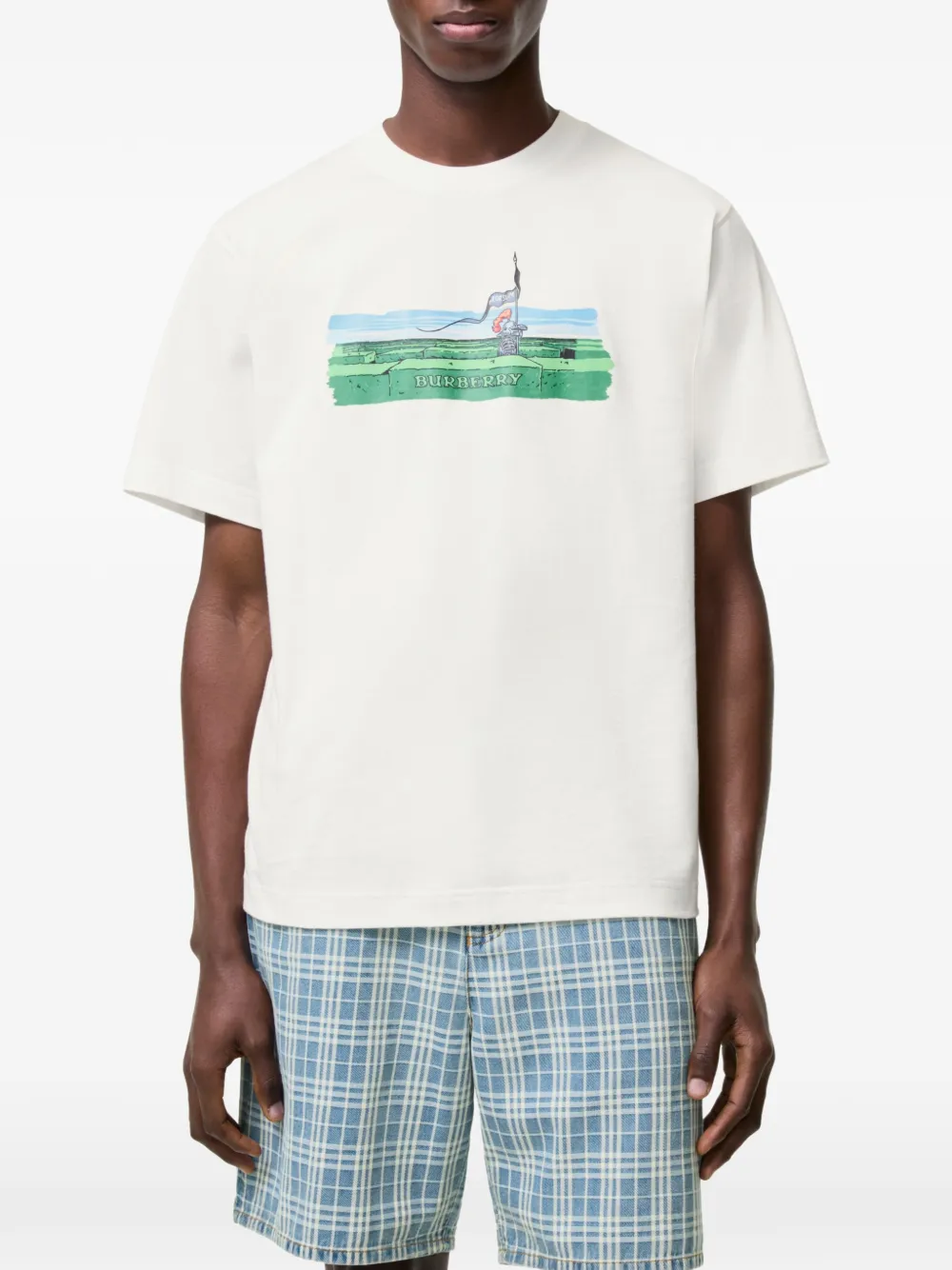 White t-shirt worn by a person, showing the white t-shirt's fit