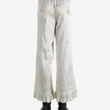 White pants worn by a person, showing the pants's fit