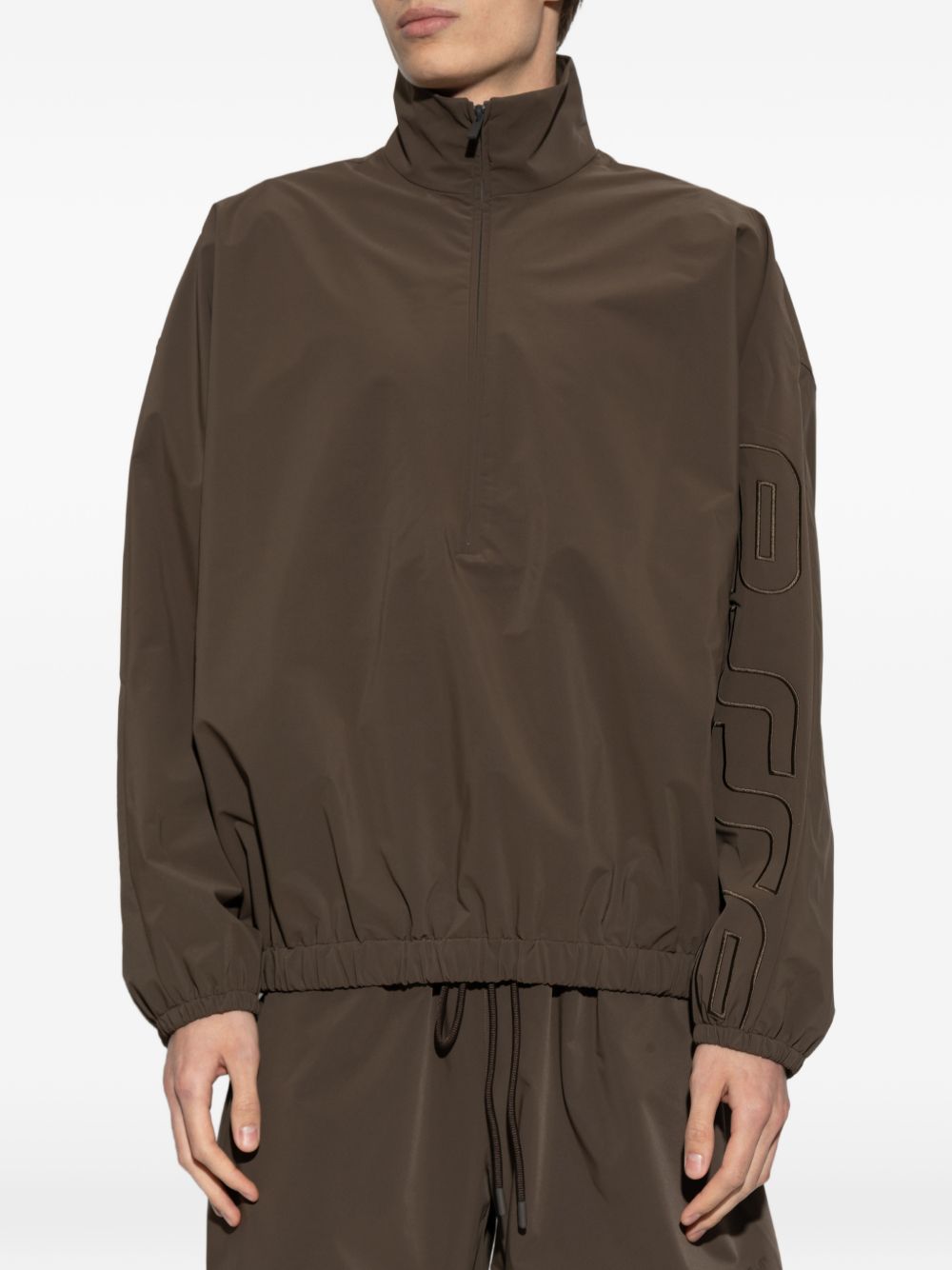 Brown jacket worn by a person, showing the jacket's fit