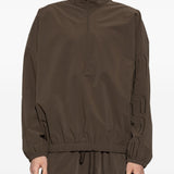 Brown jacket worn by a person, showing the jacket's fit