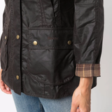 Close up of the brown jacket, showing texture of the cotton fabric