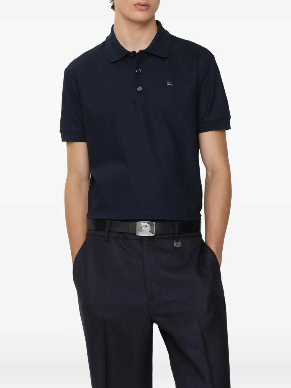 Navy polo worn by a person, showing the polo's fit