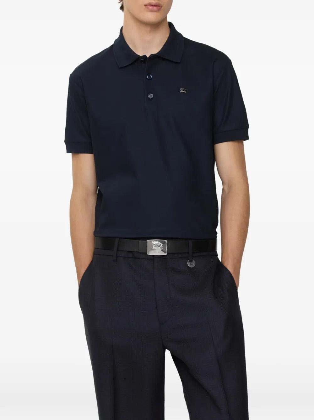 Navy polo worn by a person, showing the polo's fit