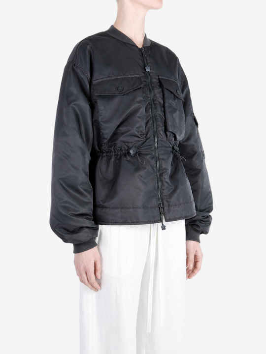 Black jacket worn by a person, showing the jacket fit