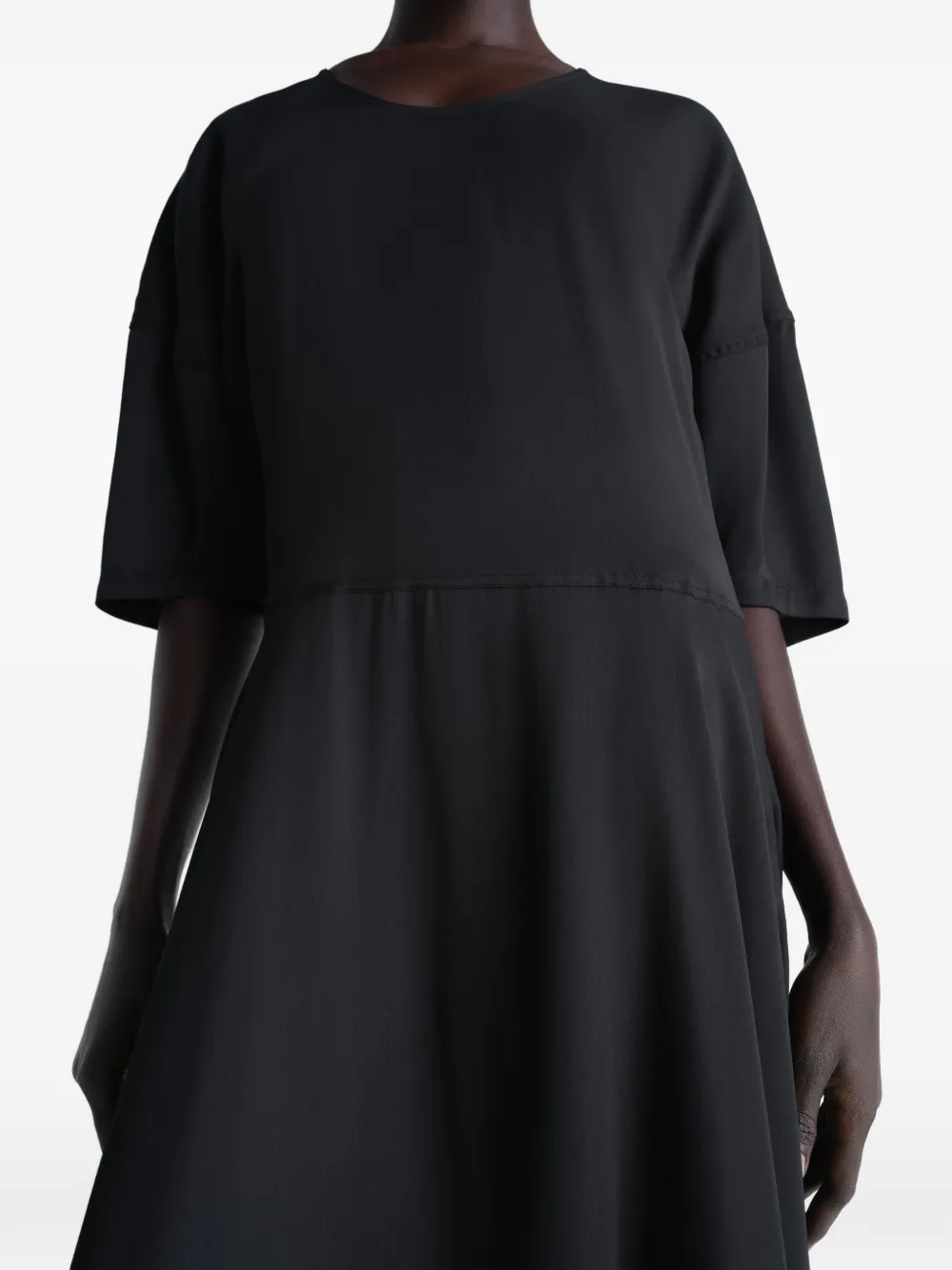 Black dress worn by a person, showing the dress fit