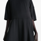 Black dress worn by a person, showing the dress fit