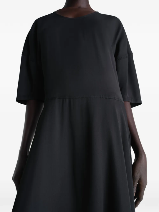 Black dress worn by a person, showing the dress fit