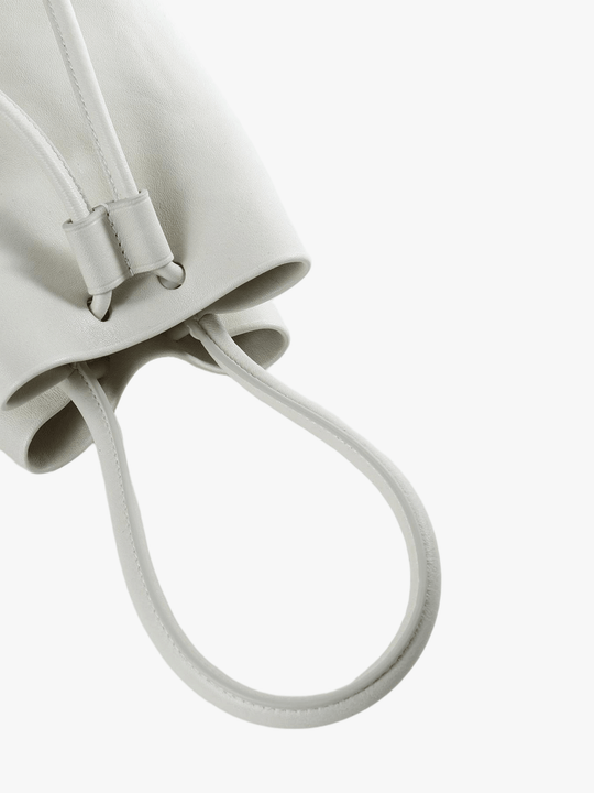Close up of white bag, showing texture of the calf leather fabric