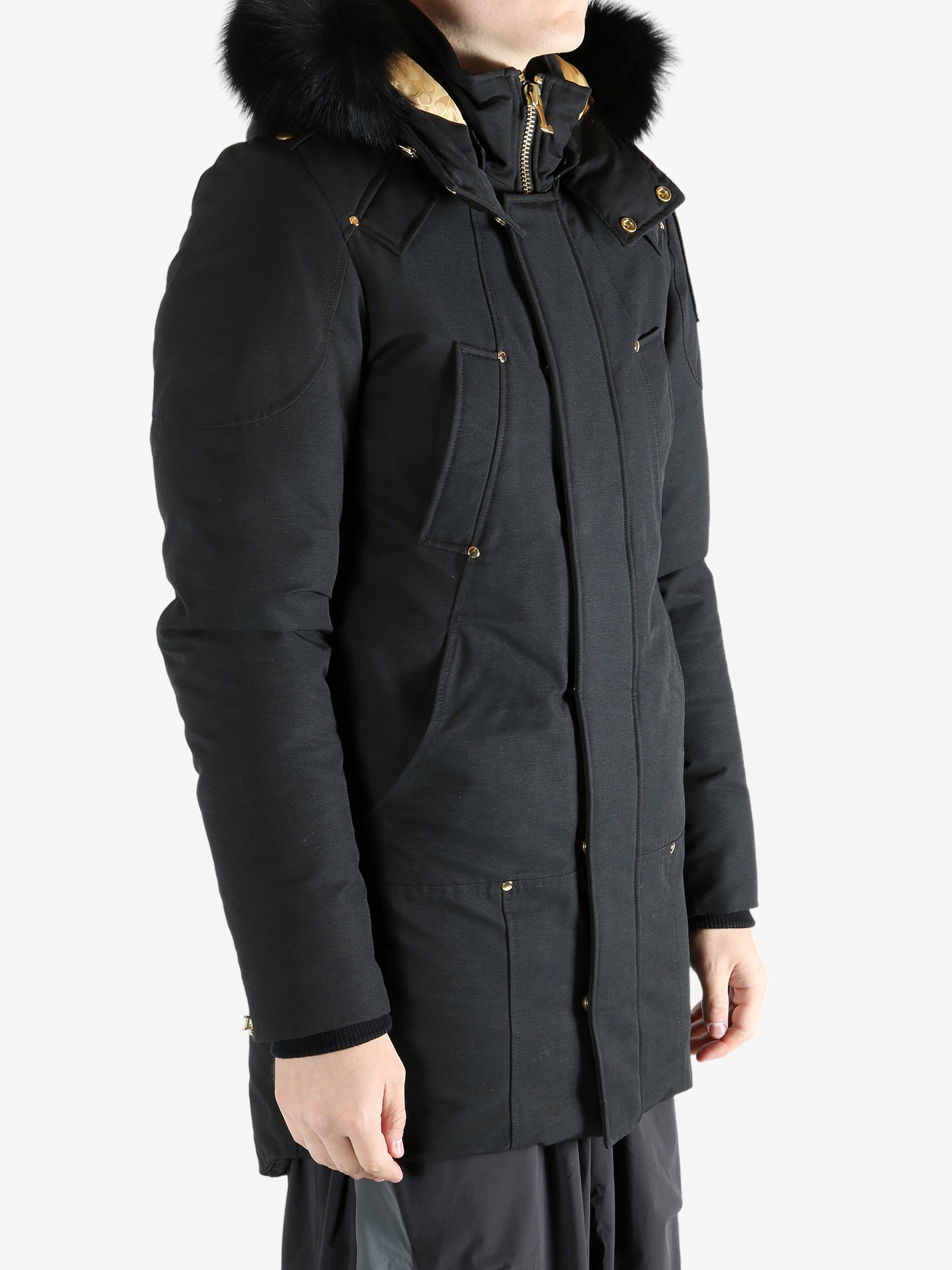 Black coat worn by a person, showing the coat's fit