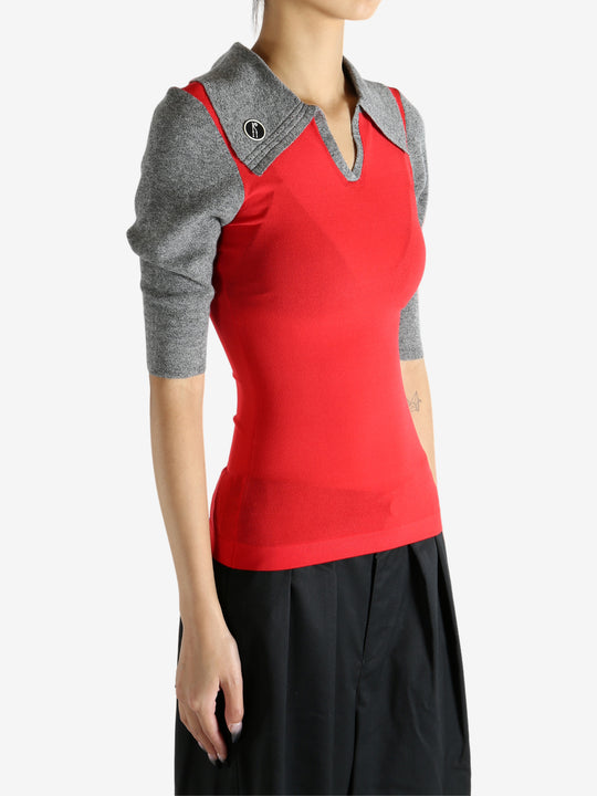 Red knitwear worn by a person, showing the knitwear's fit