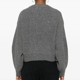 Grey knitwear worn by a person, showing the knitwear's fit