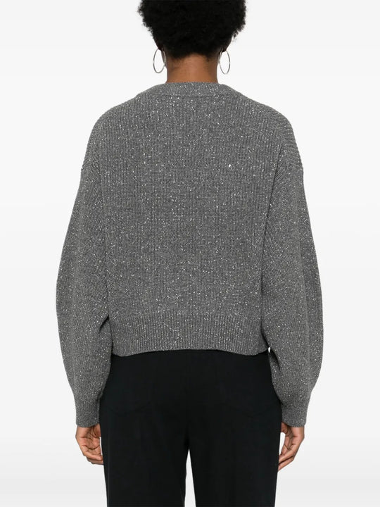 Grey knitwear worn by a person, showing the knitwear's fit